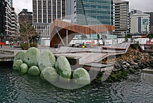 Modern North Kumutoto Pavilion on coastal decked square, and waterfront artwork of Nga Kina shells in Wellington CBD, New Zealand