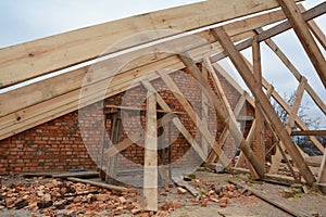 Wood framing during the roofing construction.Timber trusses, roof framing with a close-up of roof beams, struts and rafters