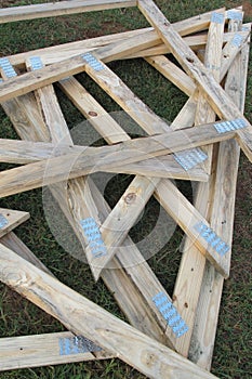 Wood gable triangle roof frame pile on grass