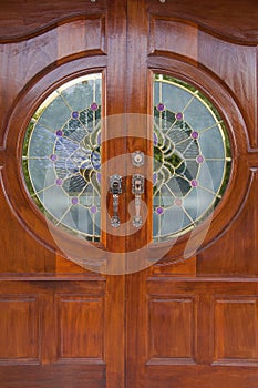 Wood grain door covers the stained glass