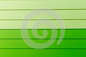 Wood green background.green Synthetic wood wall texture use for background.Colorful wooden board painted in green.