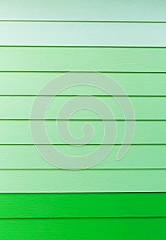 Wood green background.green Synthetic wood wall texture use for background.Colorful wooden board painted in green.