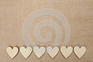Wood hearts on hessian texture background, valentine background