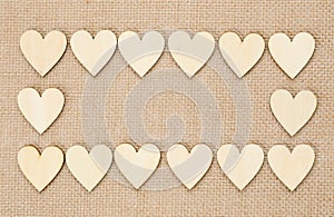 Wood hearts on hessian texture background, valentine background photo