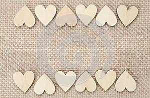 Wood hearts on hessian texture background, valentine background photo