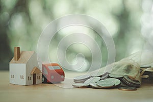 Wood home and red car with the stock of coin with natural background