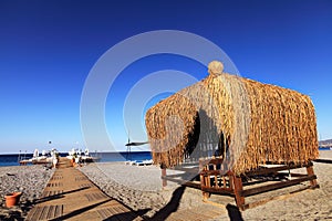 Wood hut on summer beach of sea. Resort