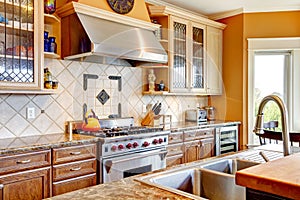 Wood kitchen room with decorated tile backsplash