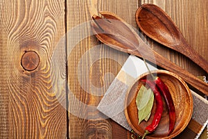 Wood kitchen utensils over wooden table background