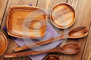 Wood kitchen utensils over wooden table background