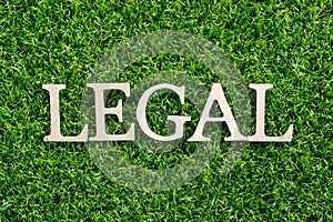 Wood letter in word legal on green grass background