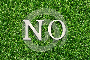 Wood letter in word no on green grass background