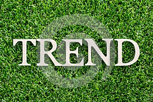 Wood letter in word trend on green grass background