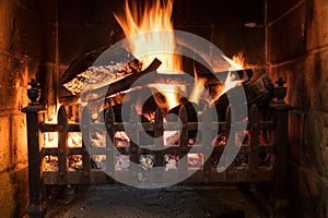 Wood Logs Fire Burning in a Traditional Country Fireplace