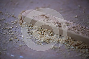 Wood lumber and shavings in carpenter workshop for making wooden furniture product.