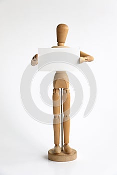 Wood mannequin holding a blank sign