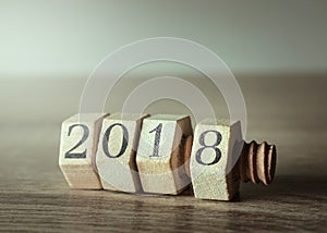 Wood nut and bolt on wood table with 2018 New Year Number.