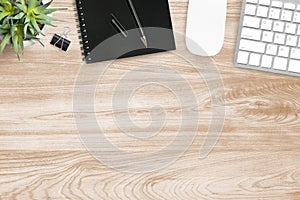 Wood office desk table with computer gadgets and supplies. Top view with copy space, flat lay