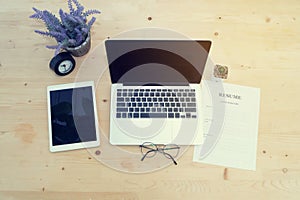 Wood Office table with blank screen on Laptop, tablet, purple la