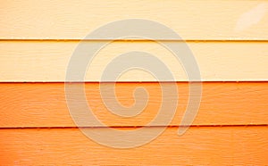 Wood orange background.orange Synthetic wood wall texture use for background.Colorful wooden board painted in orange.