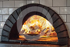 Wood oven grill lit fire brick with frying pan photo