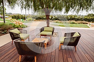 Wood patio lounge chairs with green cushions