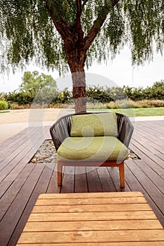 Wood patio lounge chairs with green cushions