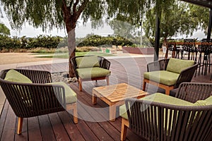 Wood patio lounge chairs with green cushions