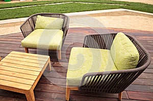 Wood patio lounge chairs with green cushions