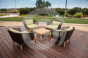 Wood patio lounge chairs with green cushions