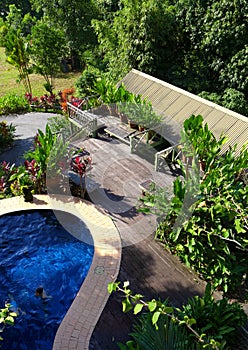 Wood patio & pool layout with landscaping photo