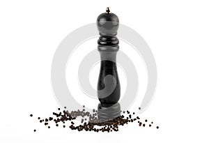 Wood Pepper Mill with black peppercorns. Isolated on white background.