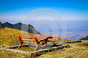 Wood picnic table and benches on top of the mountain