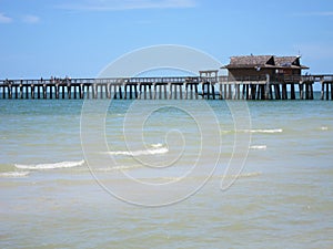 Wood pier by beach in Naples Florida