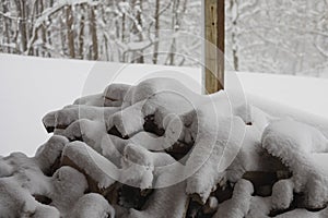 Wood pile is covered with snow