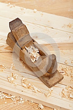 Wood plancks, plane and wooden shavings