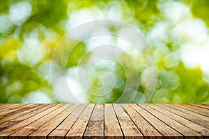 Wood plank with abstract natural green blurred bokeh background for product display