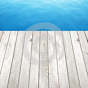 Wood plank on blue water background