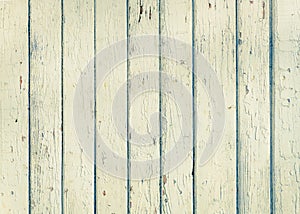 Wood plank fence with an old paint white color close up