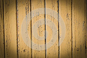 Wood planks, old yellow paint peeling off background texture