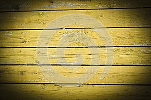 Wood planks, old yellow paint peeling off background texture