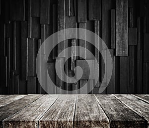 Wood planks tabletop with dark wood background