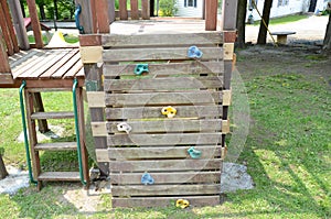 Wood play structure with stairs and climbing wall