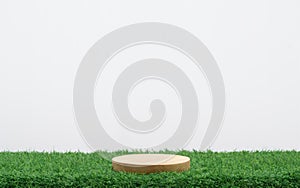 wood podium on green grass with isolated white space in background.promotion beauty cosmetic and healthy natural product placement