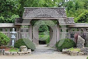 A wood privacy fence and arbor opening into a Japanese Garden at Rotary Botanic Gardens in Janesville