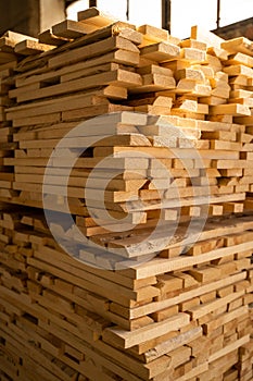 Wood processing. Stacked wooden boards at lumber warehouse in a woodworking industry. Stacks with pine lumber. Raw wood