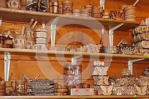 Wood products on shelf of souvenir shop. Handicraft of making wood