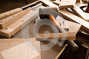 Wood products and tools lie on a workbench in a workshop