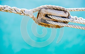 Wood pulley with nautical ropes of traditional sailing boat