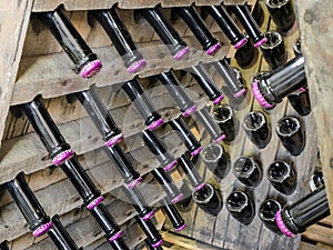 Wood rack stand with bottles of white dry sparkling wine